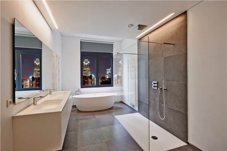 bathtub in corian, faucet and shower in tiled bathroom