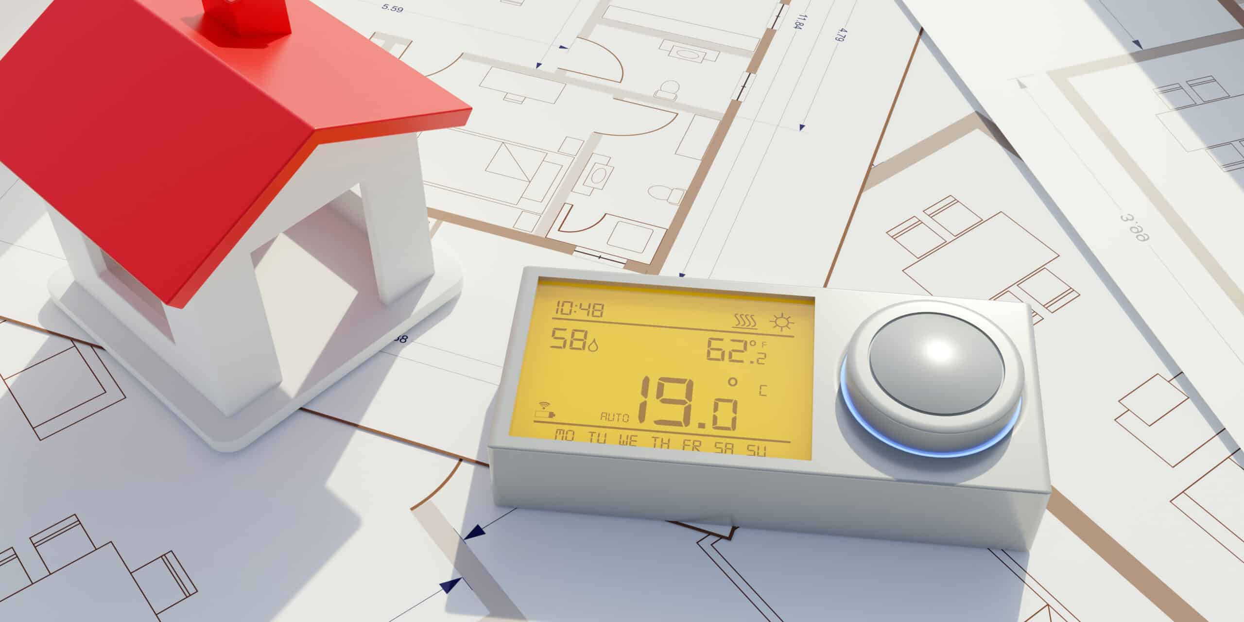 building energy cost saving. heating thermostat on house drawing.