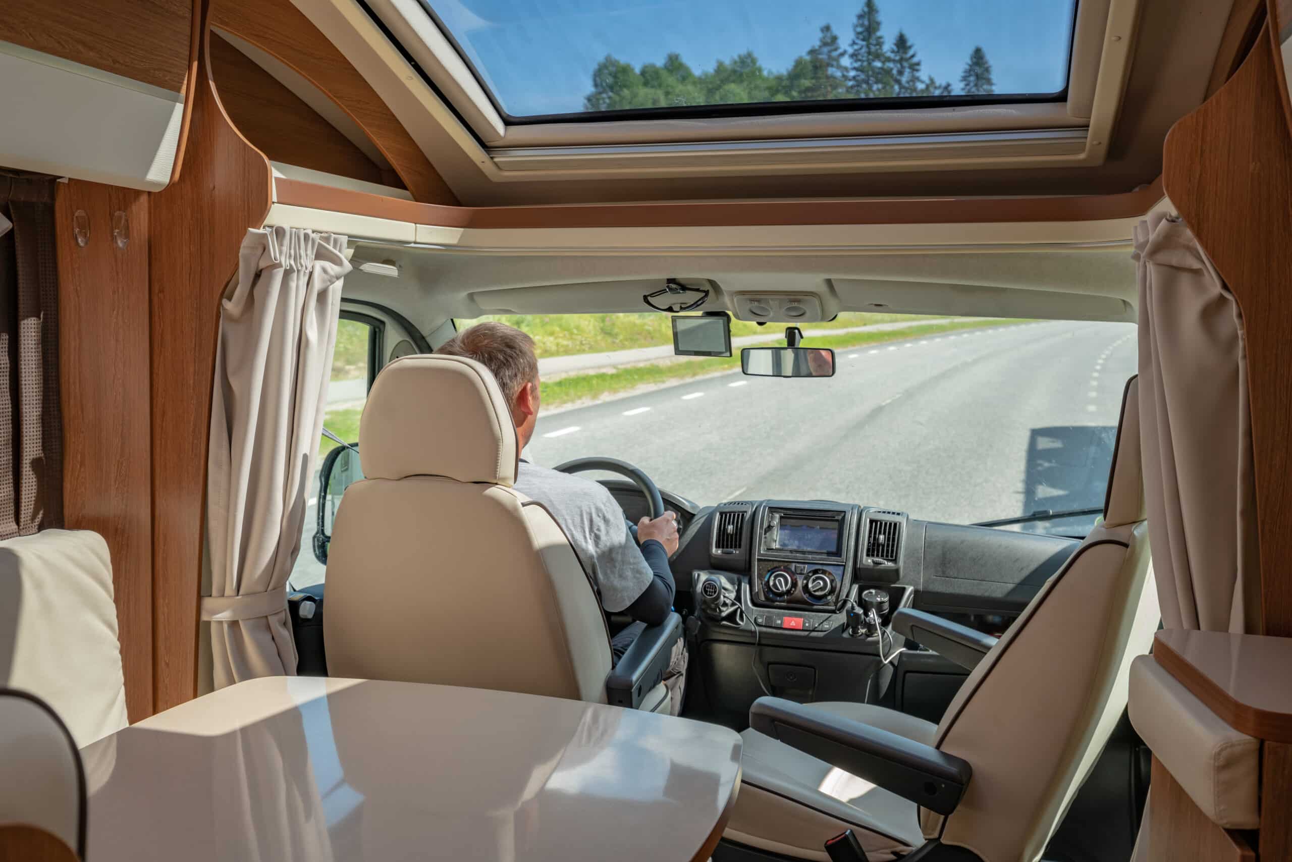 man driving on a road in the camper van rv