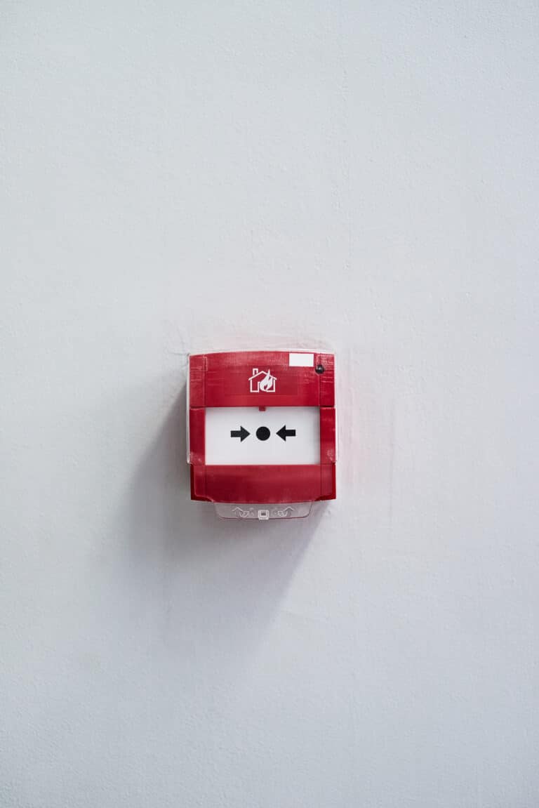press in case of an emergency. shot of a fire alarm on a wall