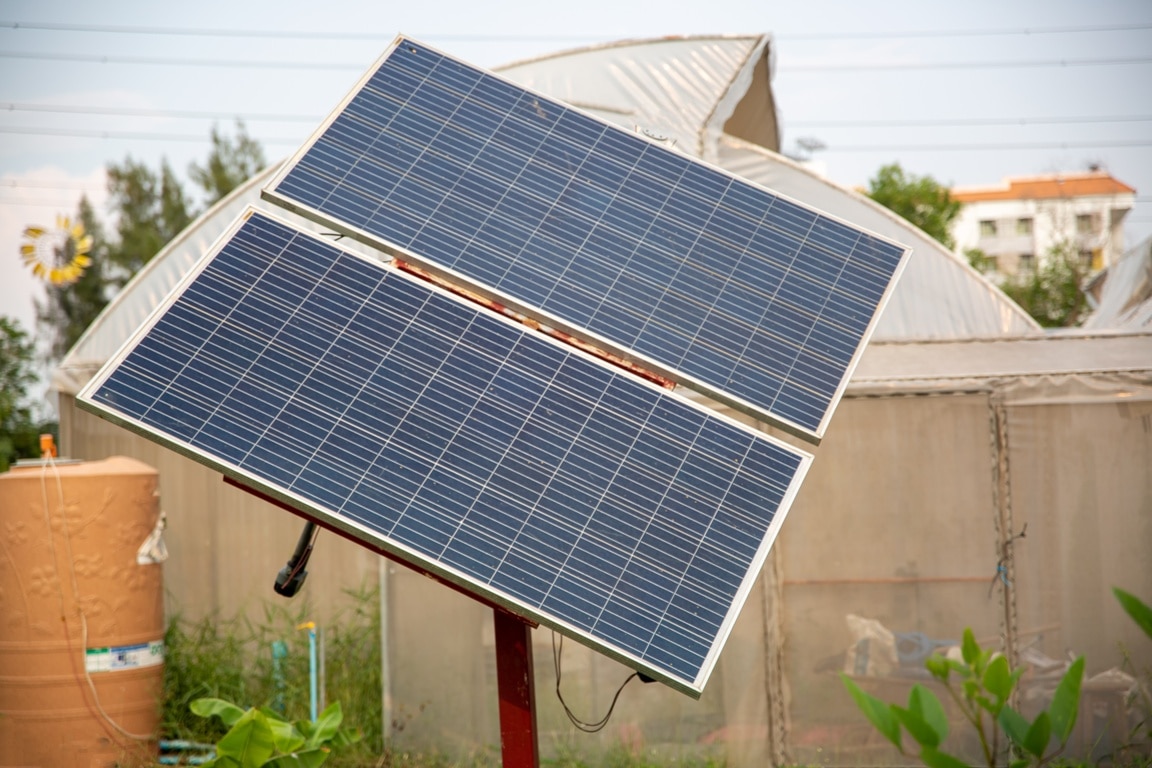 solar panels (solar cell) in solar farm with blue sky and sun lighting.