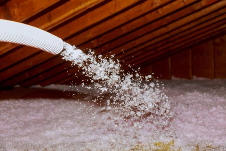 spraying blown fiberglass insulation for roof technician spraying foam insulation using plural component gun