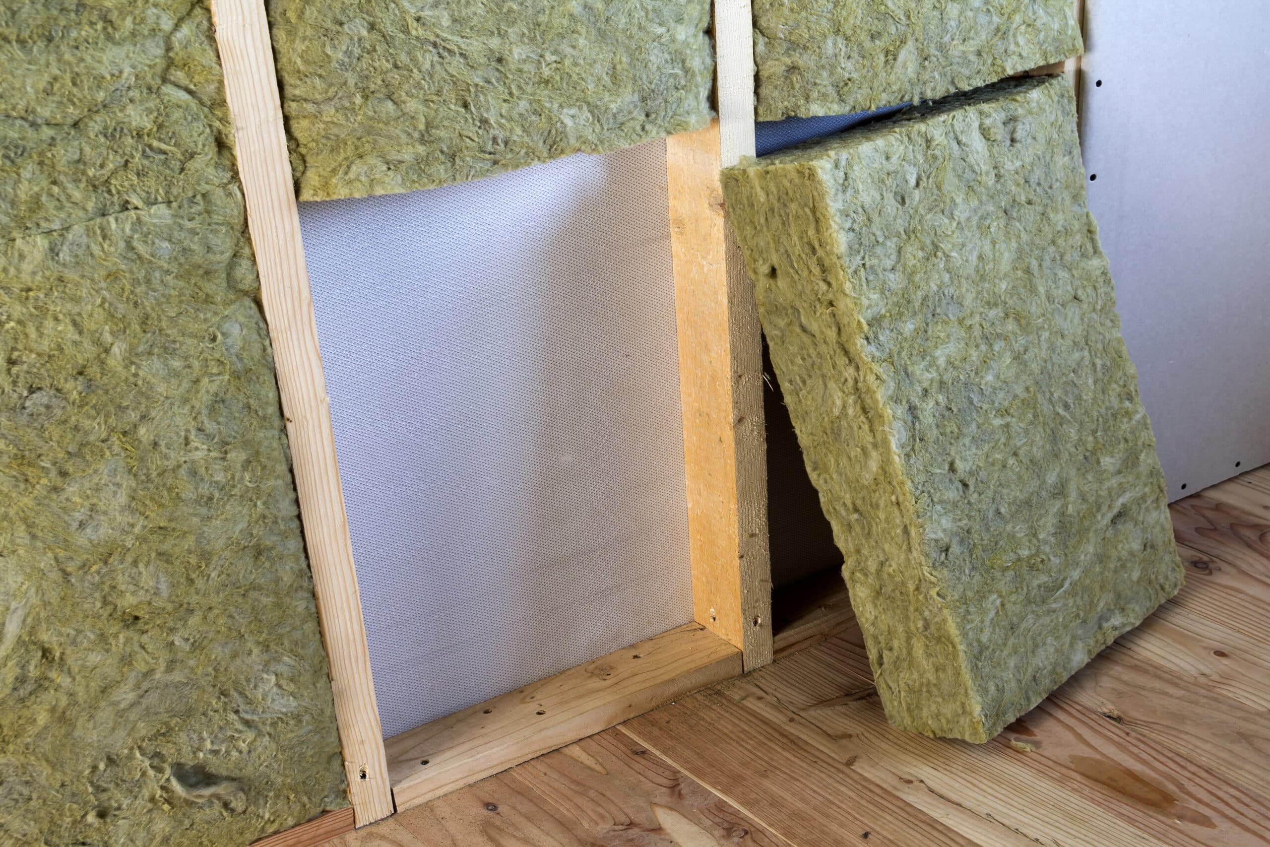 wooden frame for future walls with drywall plates insulated with rock wool and fiberglass insulation staff for cold barrier. comfortable warm home, economy, construction and renovation concept.