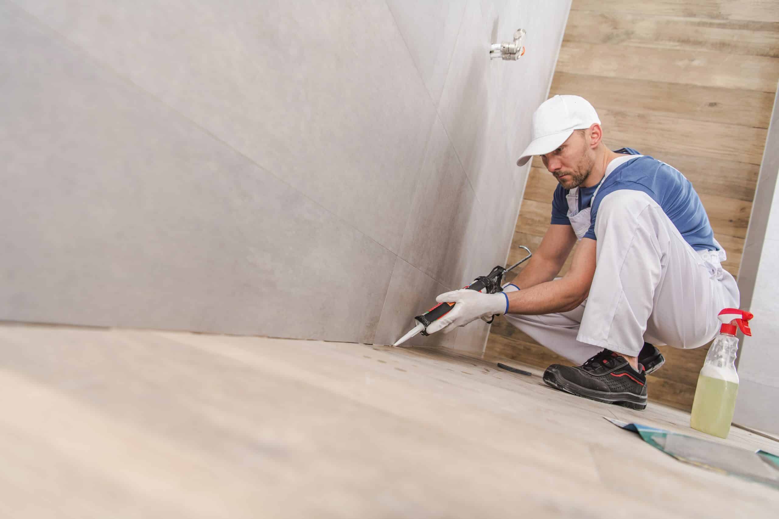 worker sealing ceramic tiles