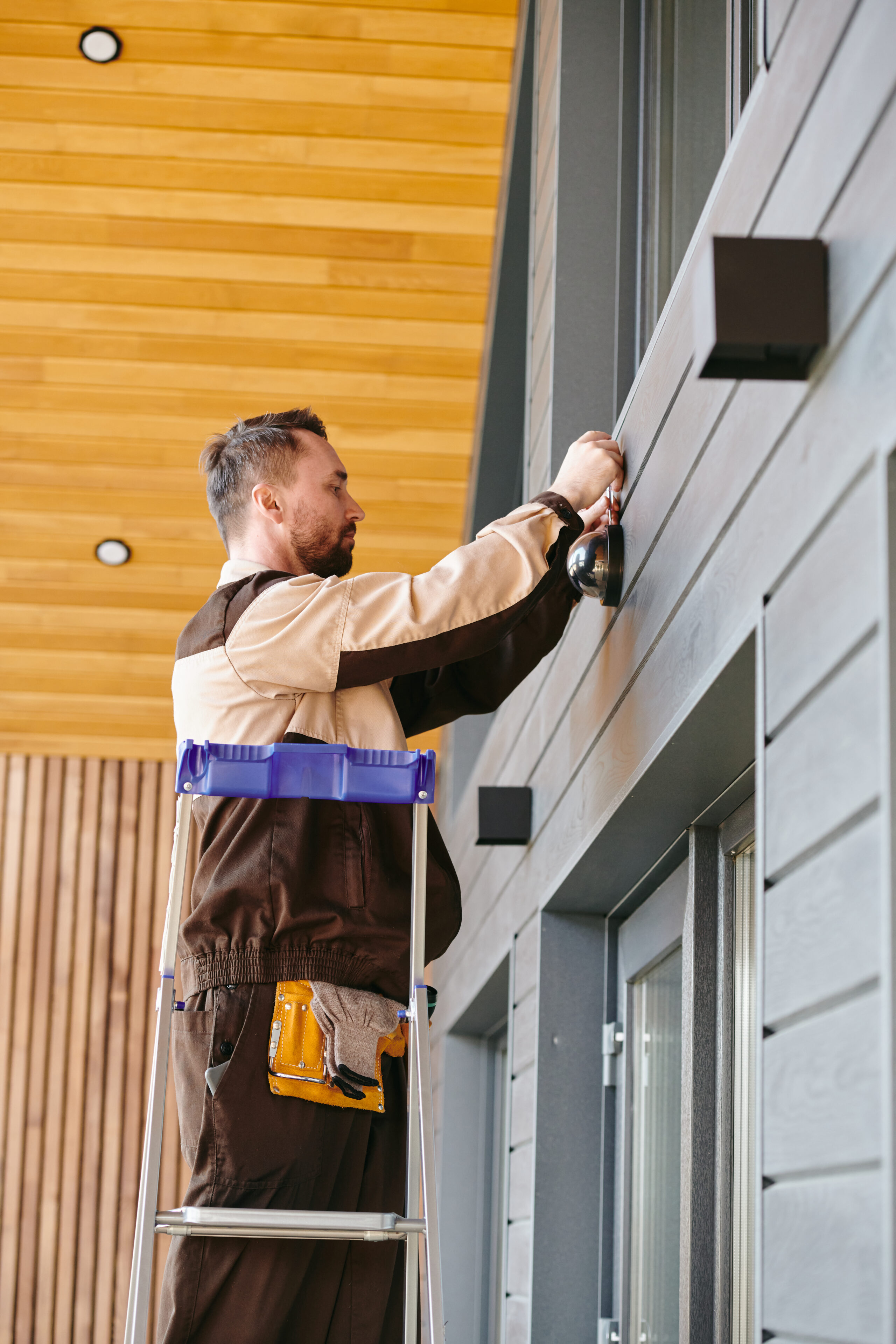 young man fixing or repairing alarm system