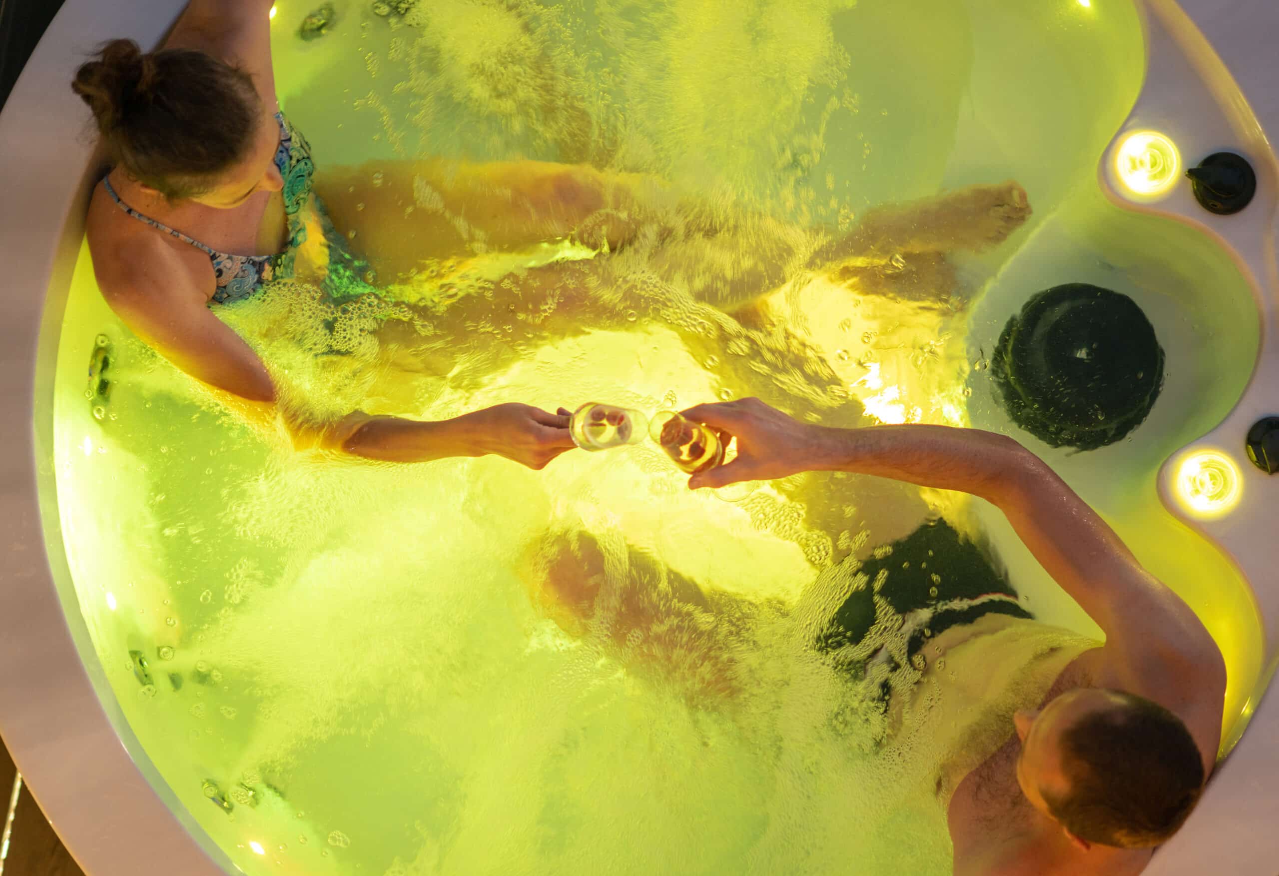 couple having great time inside their garden hot tub bath