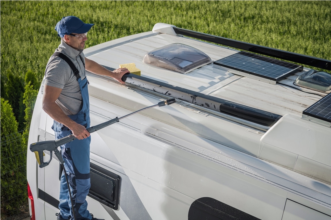 smiling caucasian men washing his motorhome rv camper van