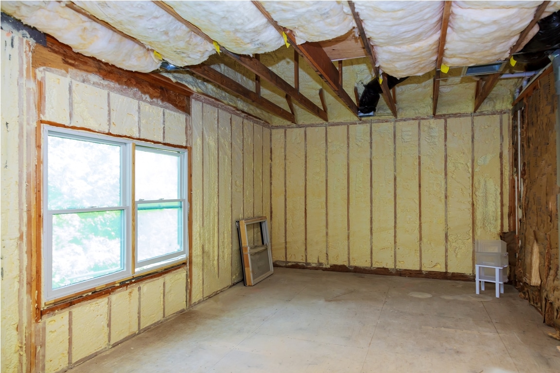 thermal and hidro insulation with spray foam at house construction site,