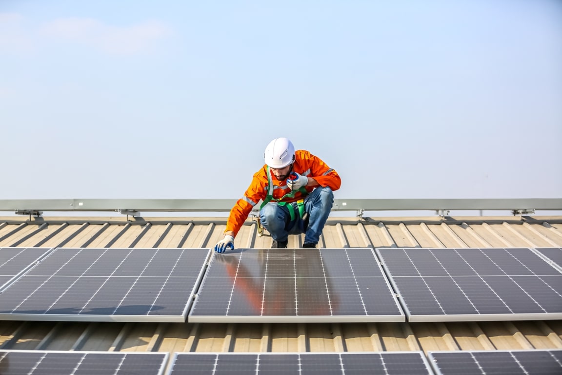 workers installing solar panels on warehouse roof 2023 06 07 17 07 40 utc