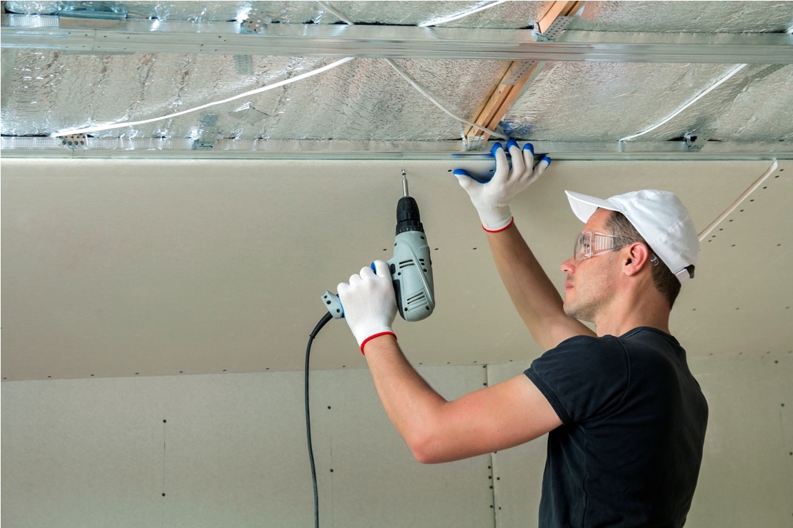 young man in goggles fixing drywall suspended ceil 2022 05 02 15 52 00 utc