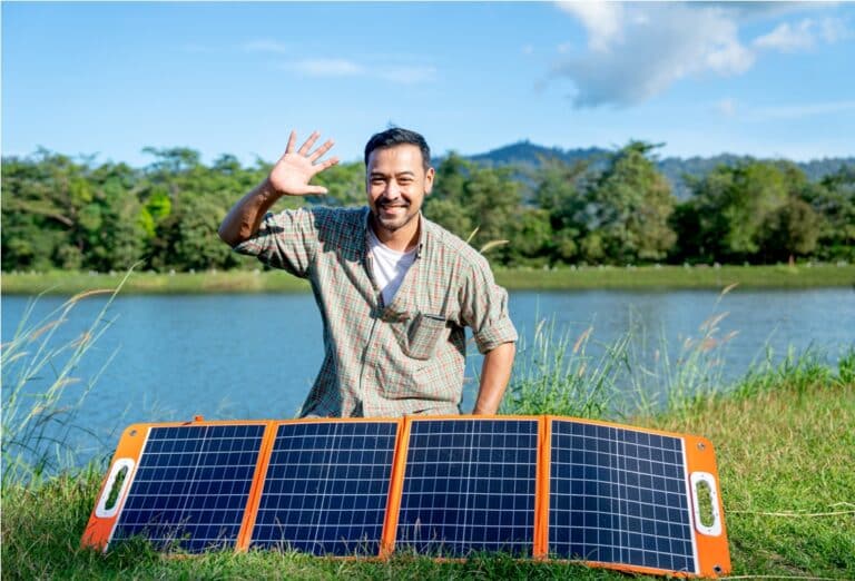asian man sit behide solar cells panel and wave ha 2023 11 27 04 56 55 utc
