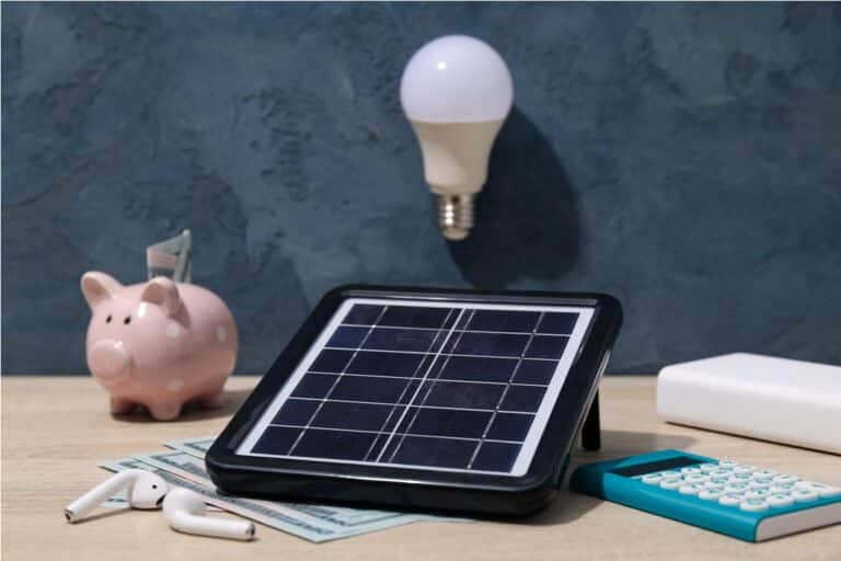 solar panel, light bulb and cash on blue background