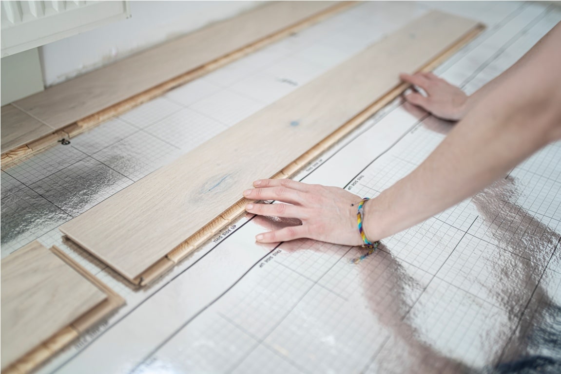 woman laying footstep sound insulation, partial view