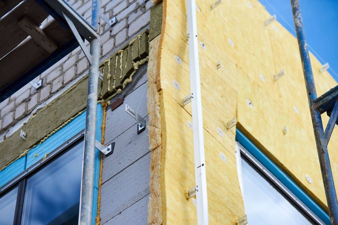 office building under construction. facing and insulation of walls.