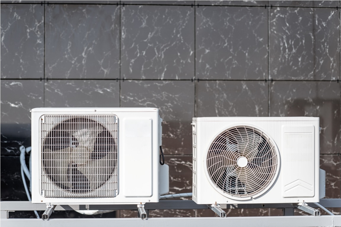 outdoor units of the air conditioner or heat pump on the building facade